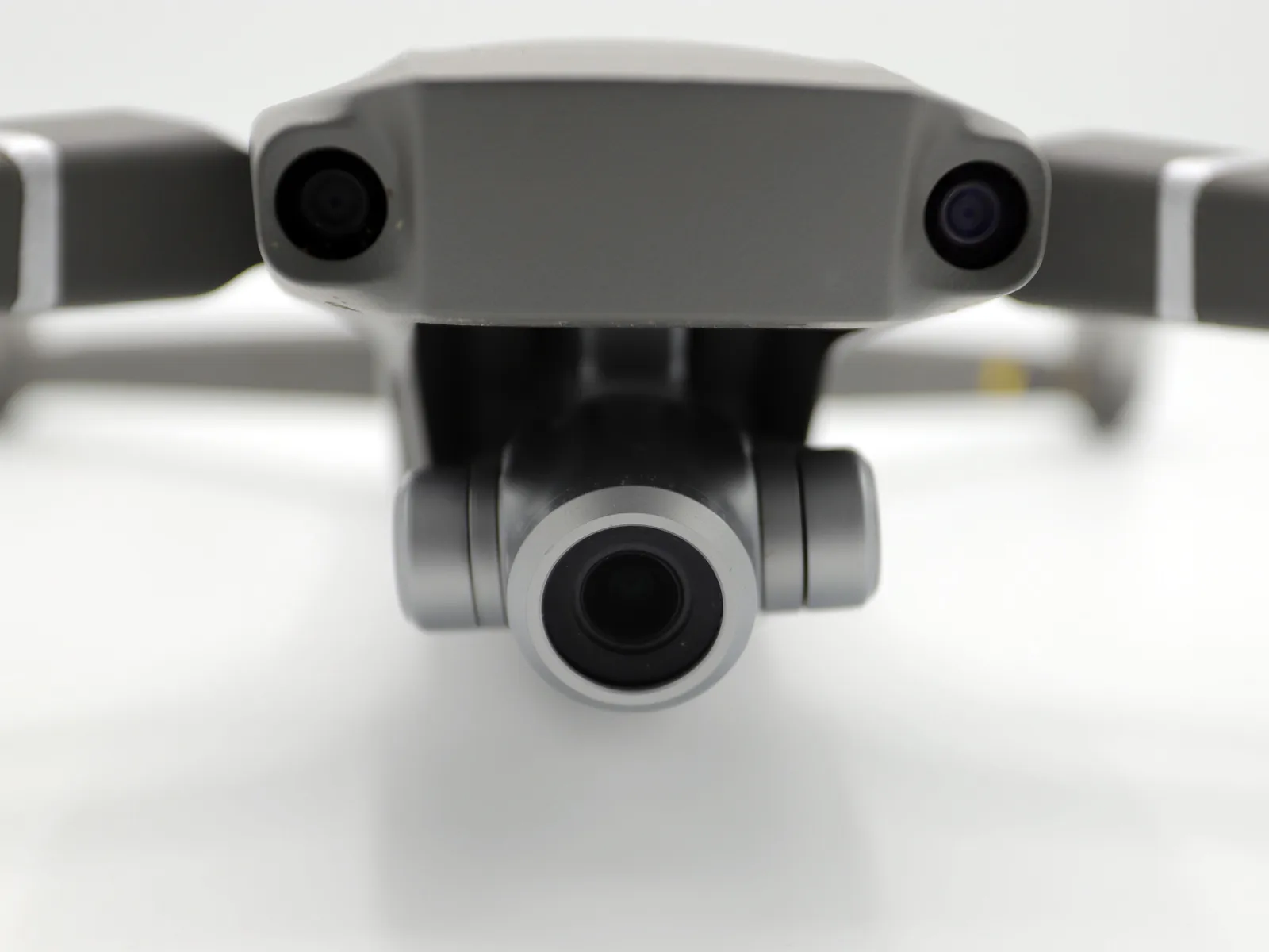 Close-up of a drone's forward obstacle-avoidance sensors and camera gimbal